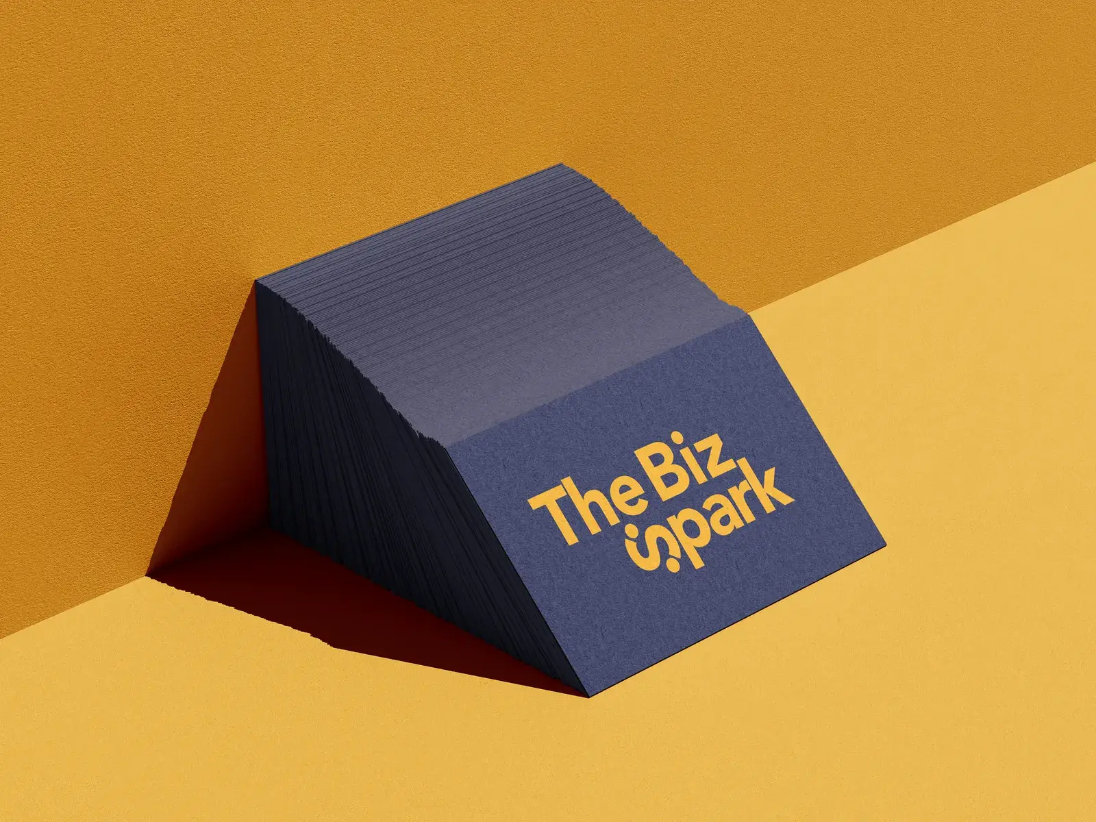 The Biz Spark navy business card stack with the gold wordmark